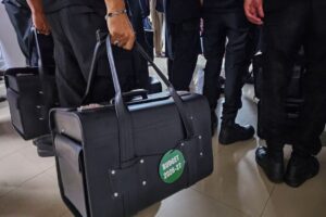 Police commandos carry bags containing copies of the 2026–27 fiscal budget at the Parliament House in Islamabad, Pakistan, June 12, 2026. Picture taken with a mobile phone. - REUTERS