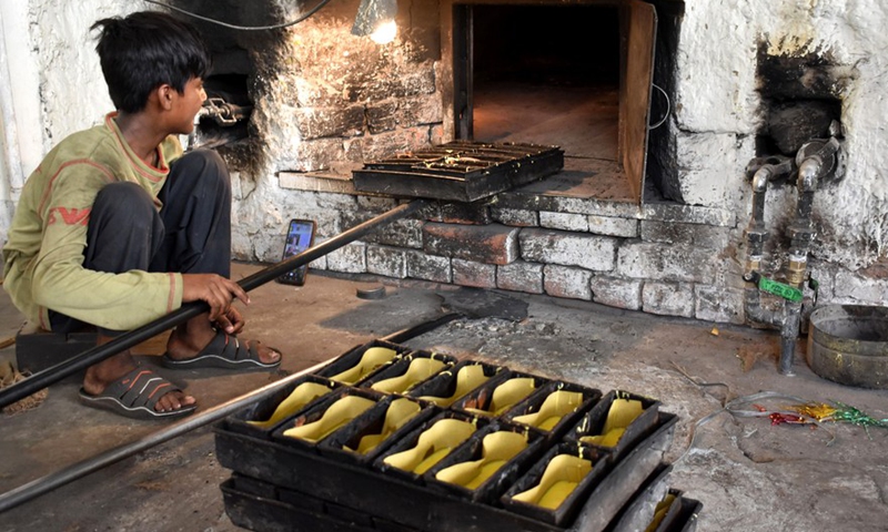 A boy works in a bakery on World Day Against Child Labor in Lahore, Pakistan on June 12, 2022. - Xinhua